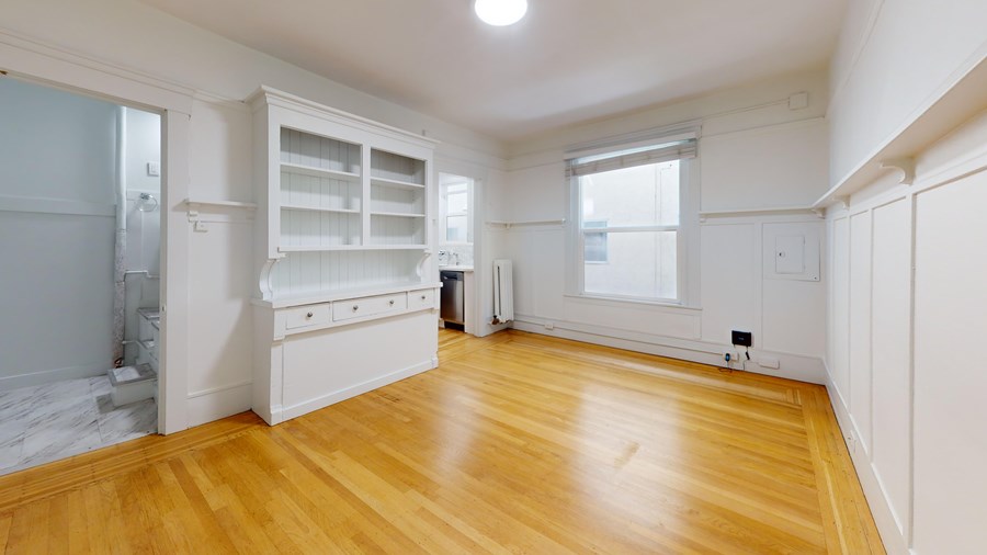 A room with a wooden floor and white walls.